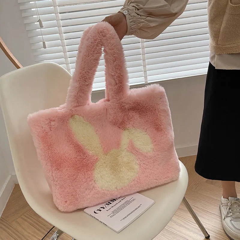 Cute cartoon rabbit ears design on a soft plush large capacity shoulder tote bag.