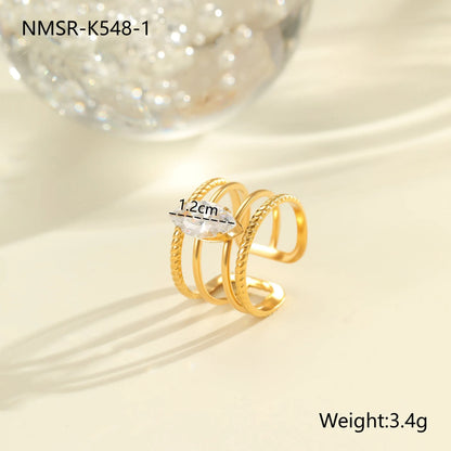 Gold electroplated stainless steel open mouth ring with geometric shapes and zircon inlay on a heart drop.