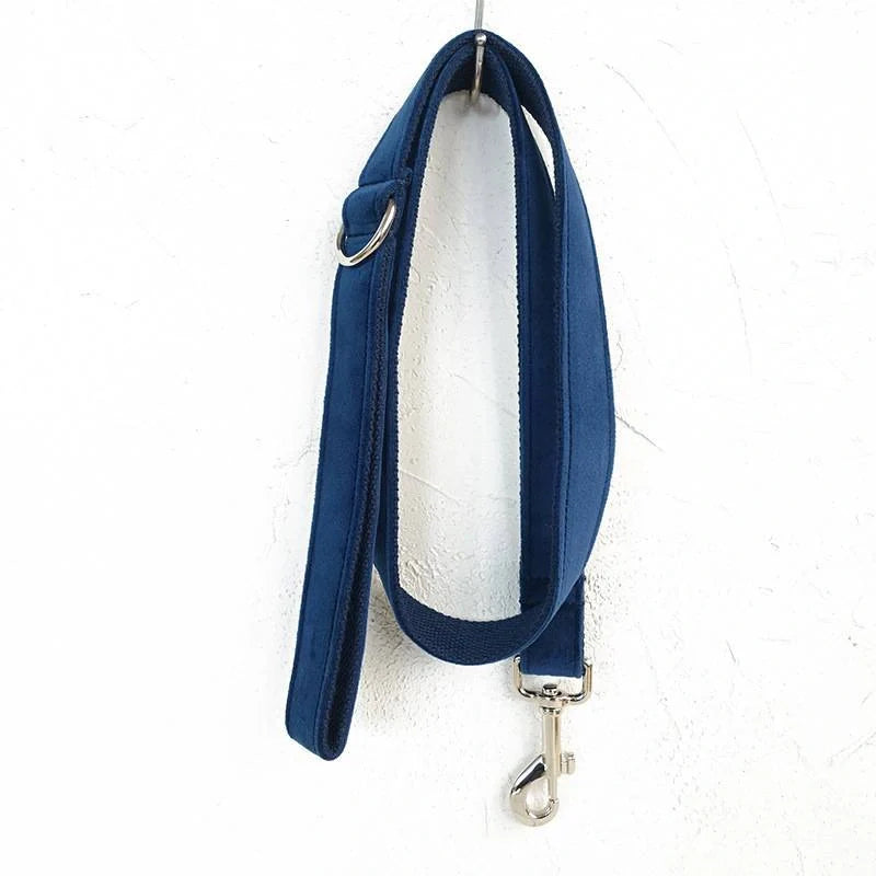 A stylish dark blue velvet pet collar with a matching bow tie accessory, perfect for dressing up your dog