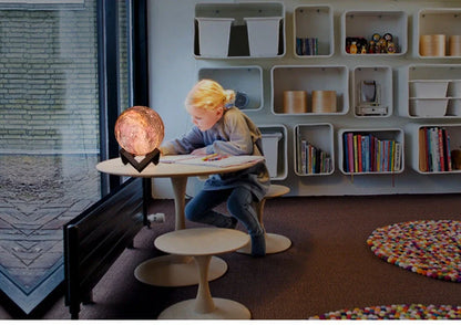 3D printed moon lamp with detailed crater surface on wooden base showing LED illumination