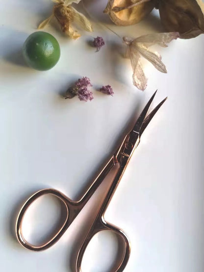 Rose gold metal scissors with durable construction and sharp blades for precision cutting