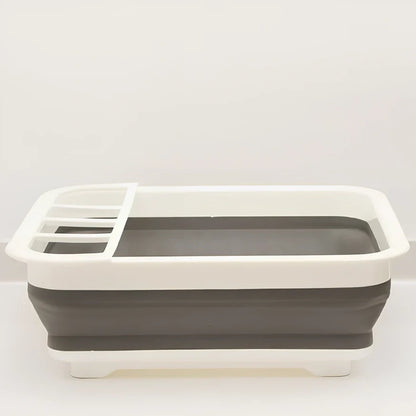 Grey folding kitchen dish rack showing collapsed flat position and separate utensil compartment