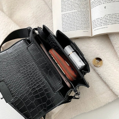 Vintage crossbody bag in black showing 20cm width, crossbody strap, and front storage compartment
