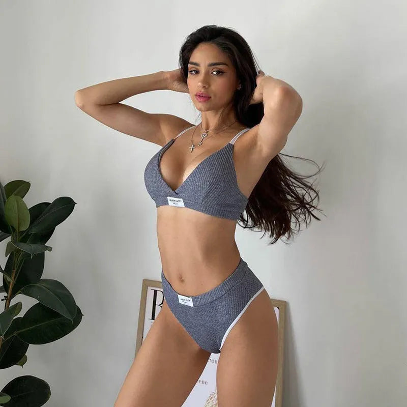 Women's black embroidered contrast binding bikini set with sleeveless top and shorts on a mannequin.