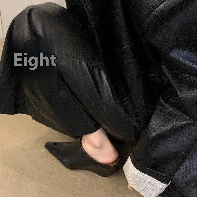 Women's black wind wedge closed toe half slippers on a plain background.