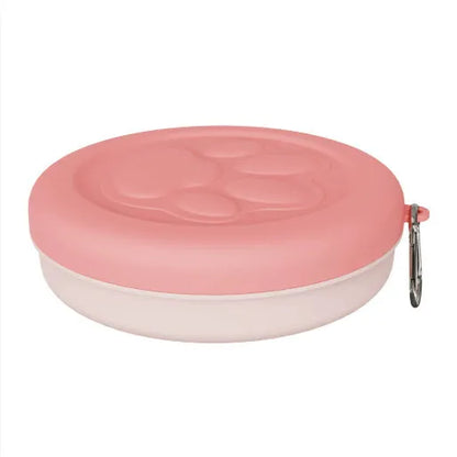 Collapsible silicone dog bowl with integrated snack compartment in light pink colour