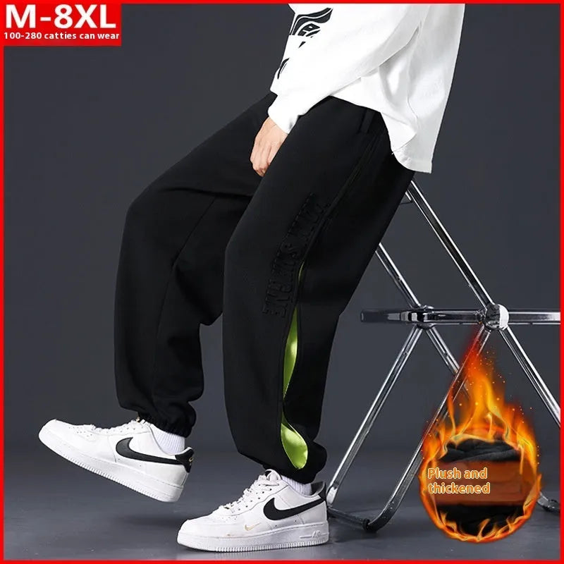 Men's ankle banded trousers in micro-elastic cotton with collage stitching details, showing loose fit and tapered leg