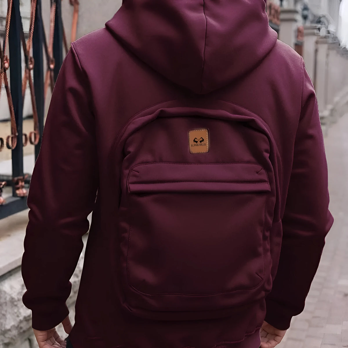 Men's loose-fit hoodie cardigan sweater with back schoolbag design and stick pocket in light grey, black and blue.