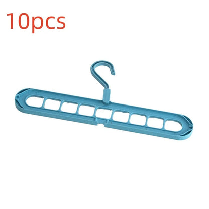 Green nine-hole folding hanger with trousers organised across nine hanging points, showing 45cm width