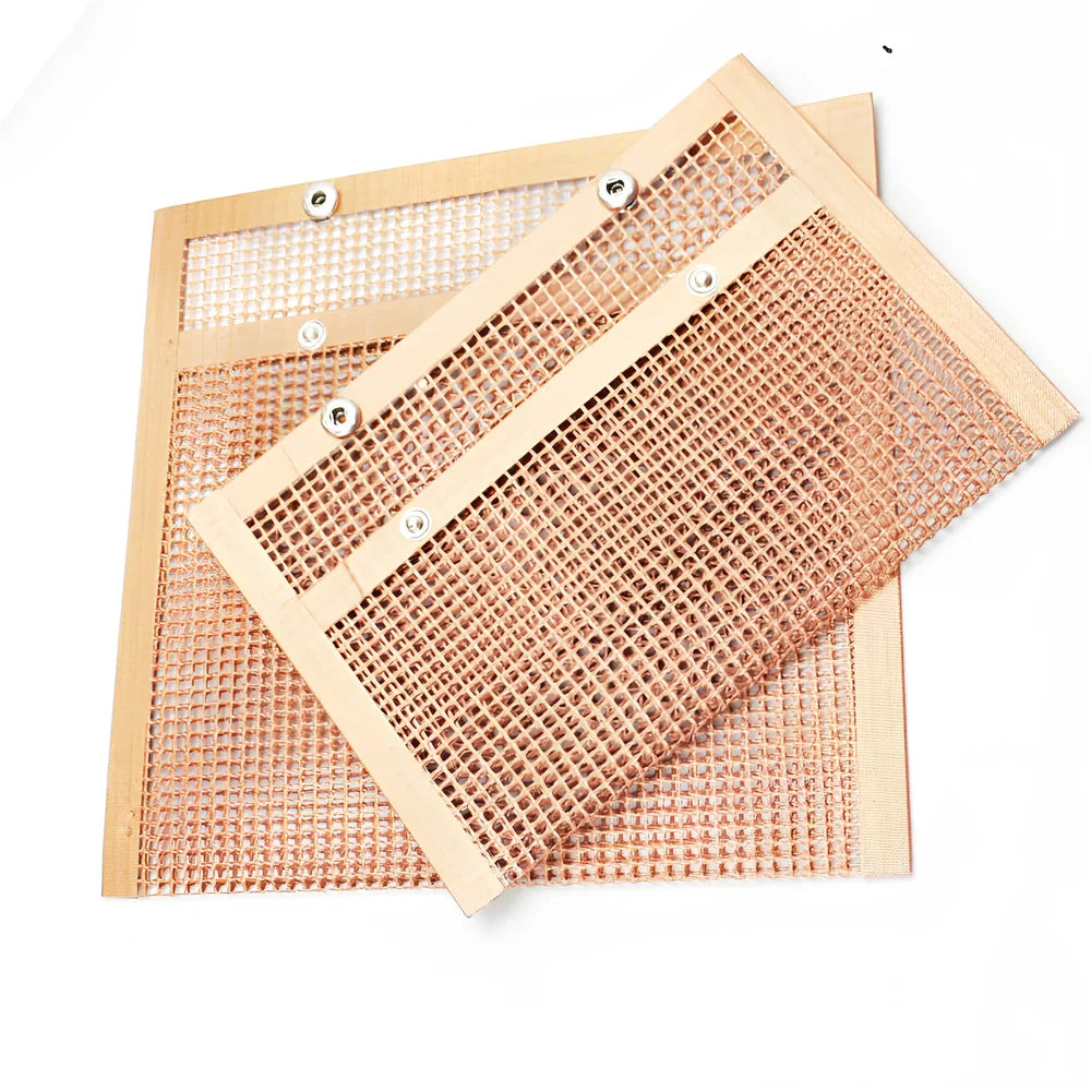 Black grill mesh bag with non-stick grid mat on barbecue, showing smoke circulation through mesh design