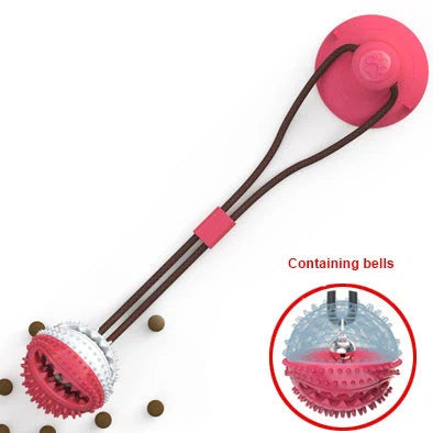 Red and blue silicone dog ball toy with suction cup attached to tile surface