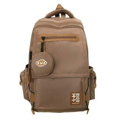 Large nylon school backpack for middle school students in a solid colour with curved shoulder straps.