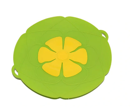 Green silicone spill stopper pan lid on cooking pot showing flexible edges and steam vent
