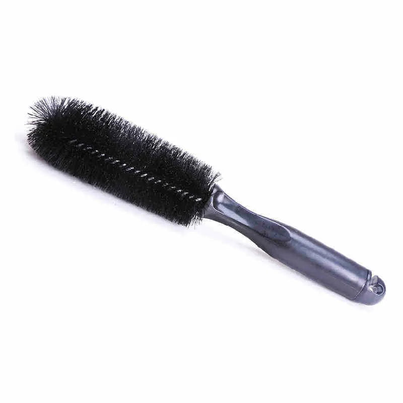 Car tire wheel brush with long handle and twisted yarn bristles for wheel hub cleaning.