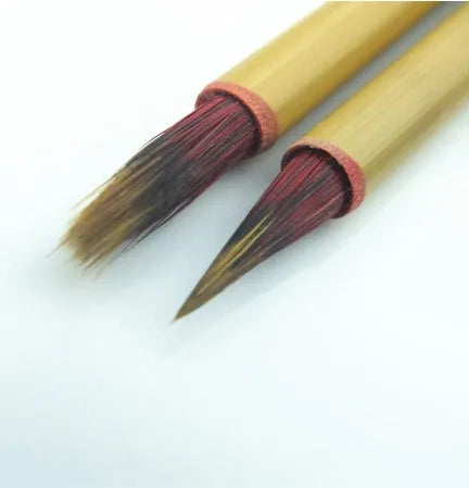 Red Chinese calligraphy brush with a 1.6cm long brush head and a 23cm wooden penholder.