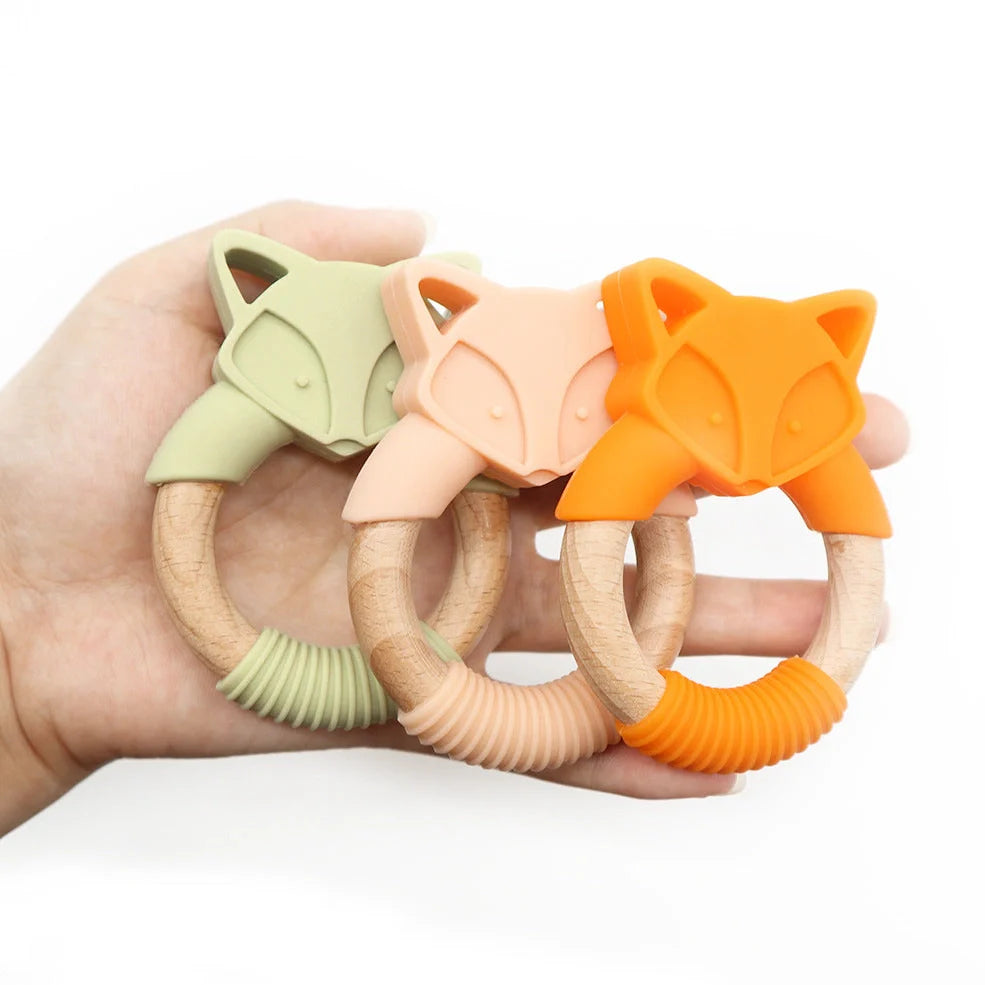 Wooden fox teether with orange silicone ring measuring 80mm high