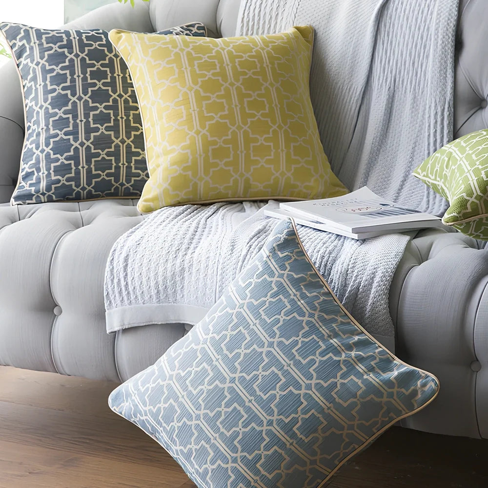 Square beige cushion cover with envelope closure on a grey sofa