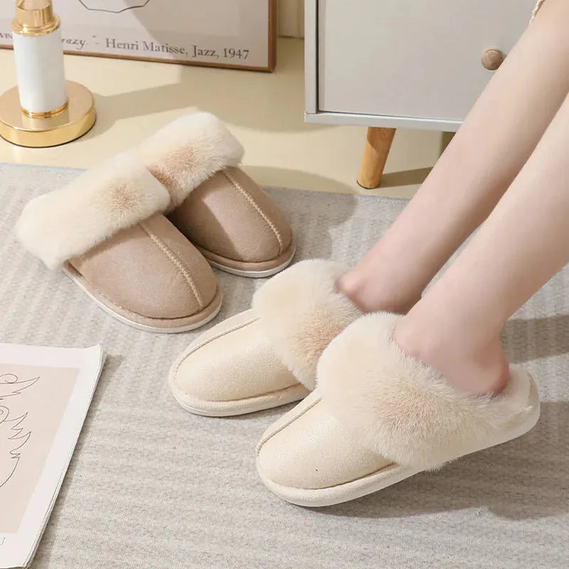 Women's plush indoor slippers in a selection of colours with a fuzzy upper and flat sole.