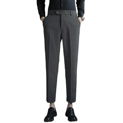 Straight-leg brown corduroy trousers with elastic waistband and slim fit design