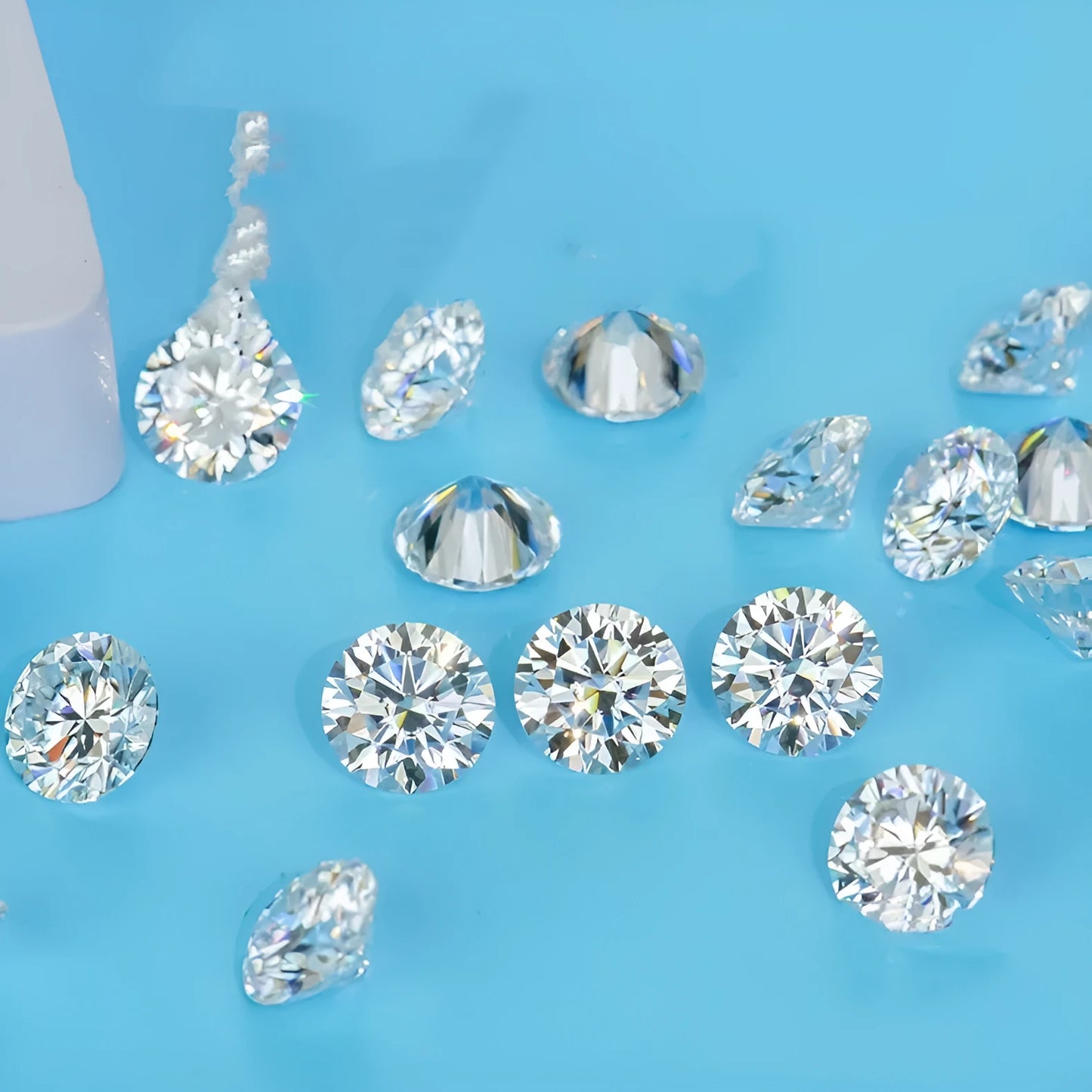 Round moissanite gemstone showing eight hearts and eight arrows cut pattern.