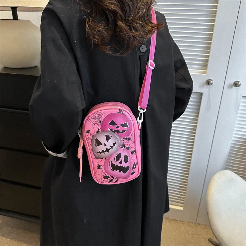 Halloween graffiti print crossbody bag in black with pumpkin, ghost, and bat designs, measuring 14x23x9.5cm