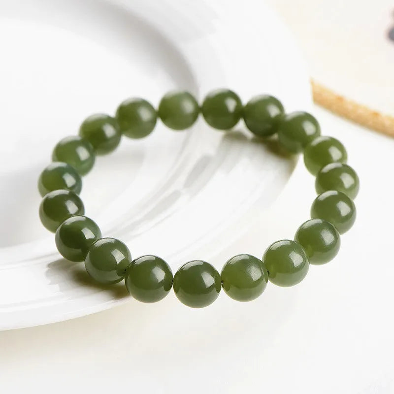 Hetian jade ball bracelet with polished spherical beads in ice-like clear water colours on wrist