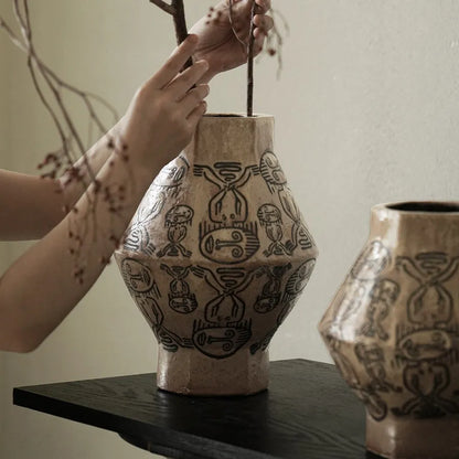 Hand-painted ceramic vase with religious patterns and carved texture in cylindrical shape