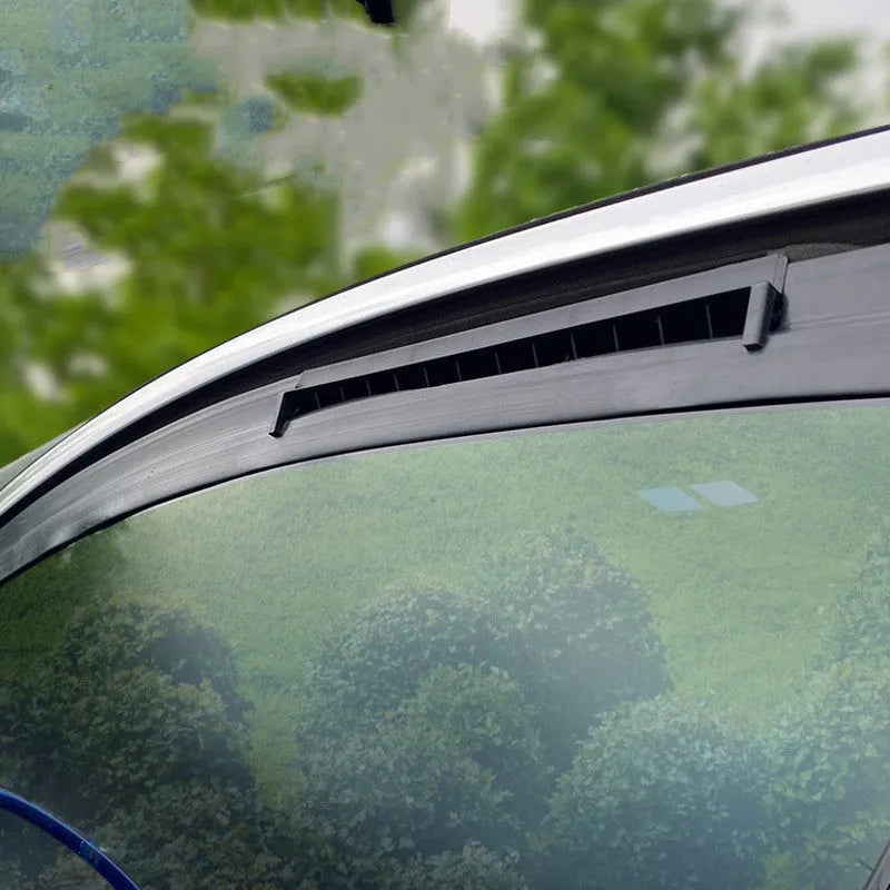 Compact black and white USB-powered car ventilation fan on a dashboard.