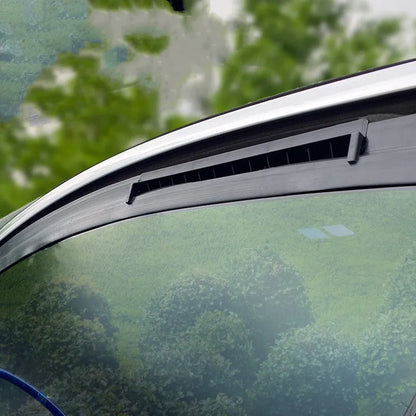 Compact black and white USB-powered car ventilation fan on a dashboard.