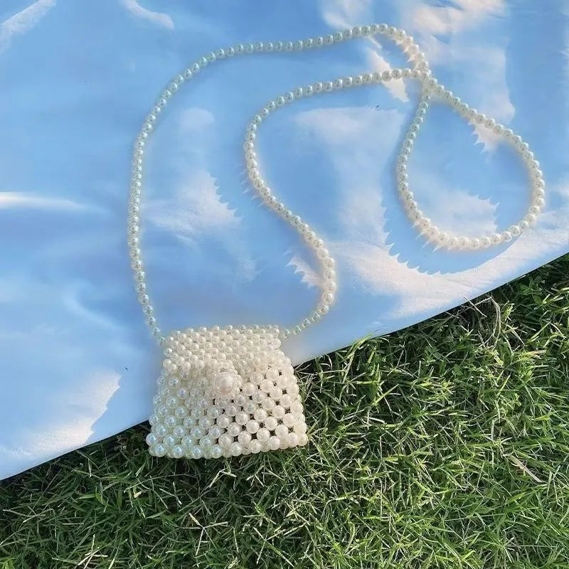 Women's imitation pearl mini crossbody handbag with geometric pattern in a pearl colour.