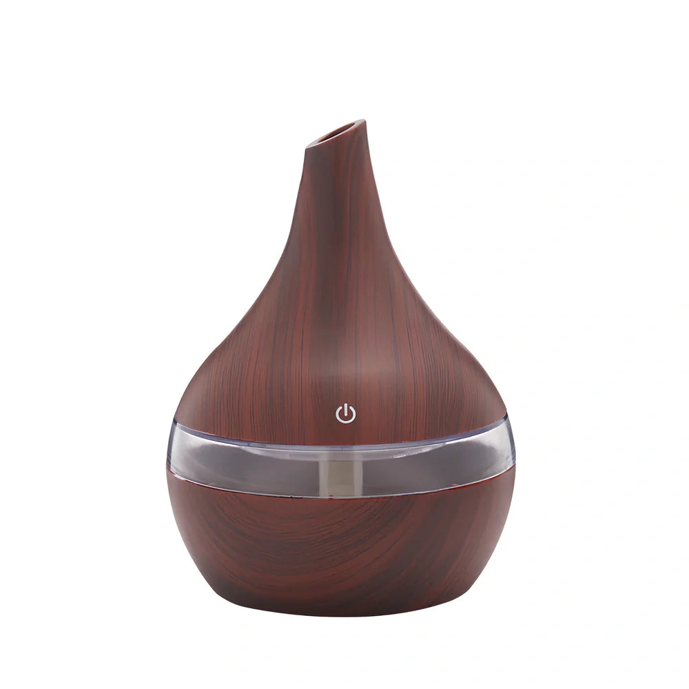 Round wood grain humidifier with USB cable on wooden surface