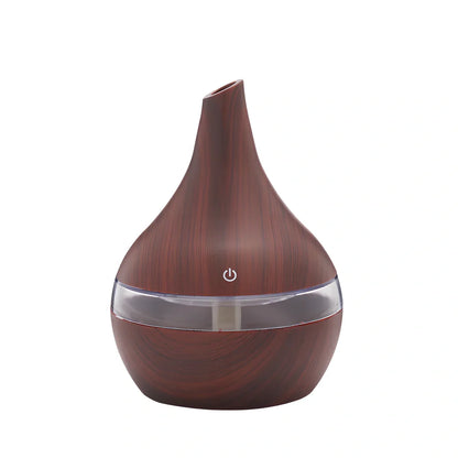 Round wood grain humidifier with USB cable on wooden surface