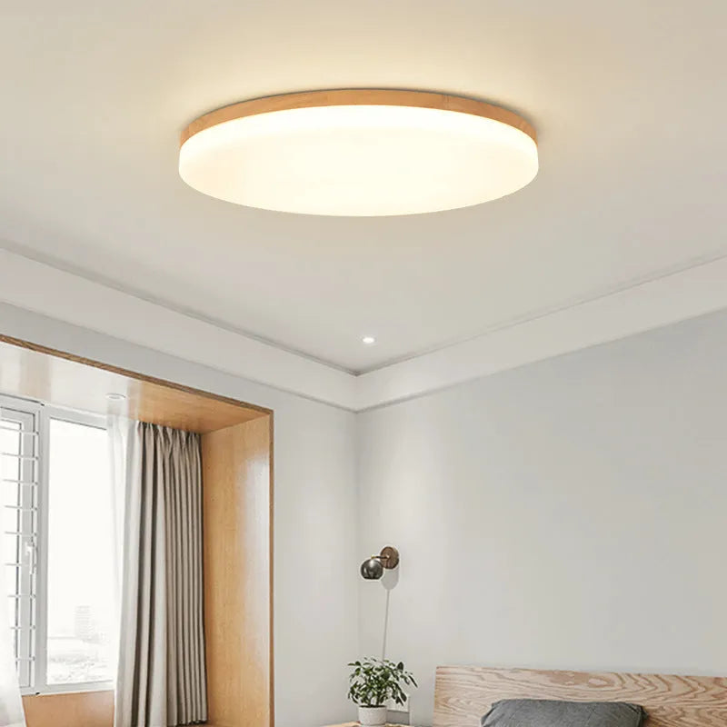 Japanese minimalist wooden and acrylic LED ceiling lamp with three-colour lighting on a white ceiling.