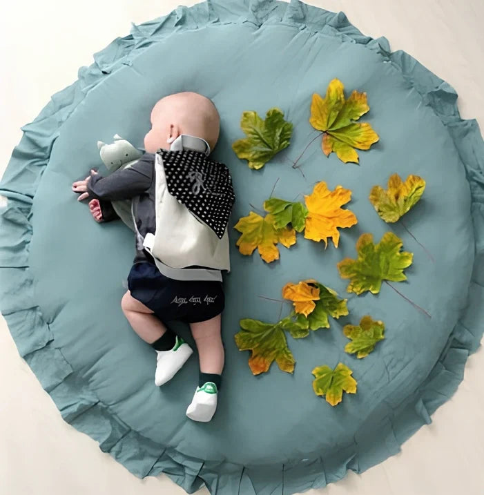 Circular baby play mat with lace border showing 2cm thickness measurement
