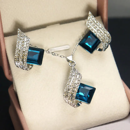 Women's alloy pendant and glass necklace with matching electroplated ear studs in cross chain style.