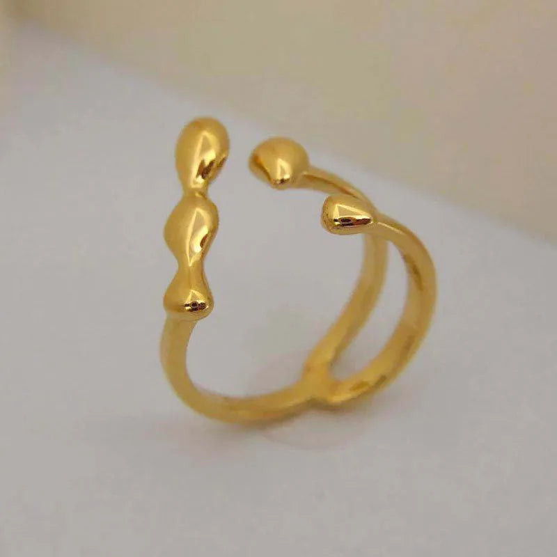 Gold and silver adjustable brass ring featuring a large spherical design on an open shank.
