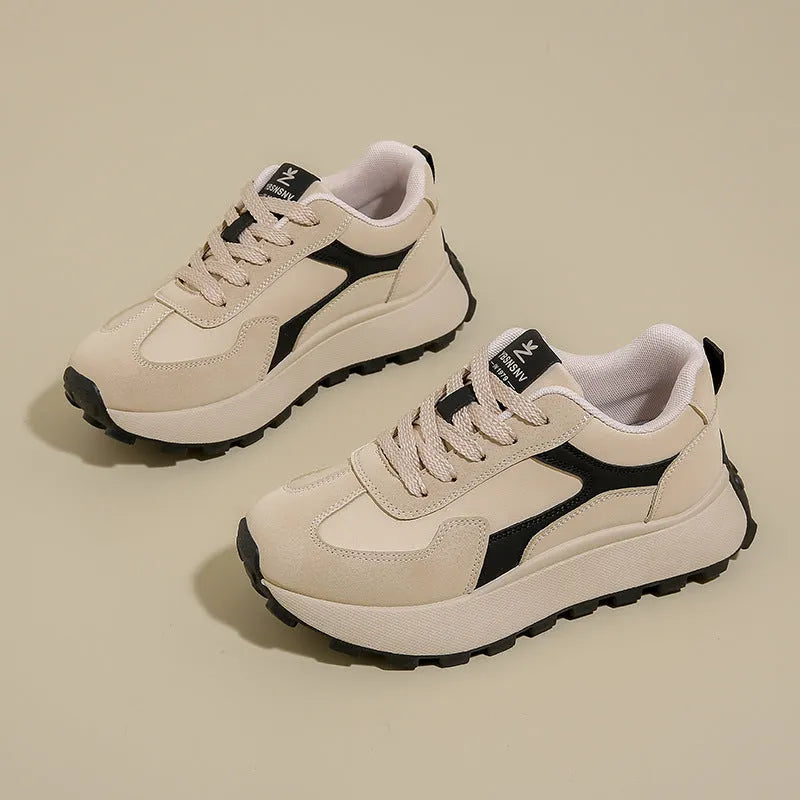 Women's solid colour low-top sports shoes with flat platform sole and lace-up front.