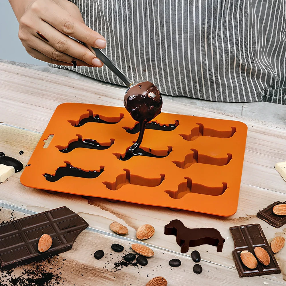 Orange silicone ice mould with 12 animal-shaped compartments for making decorative ice cubes
