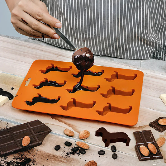 Orange silicone ice mould with 12 animal-shaped compartments for making decorative ice cubes