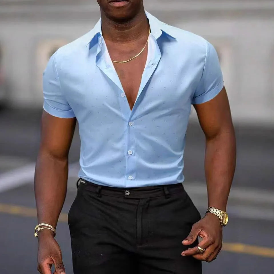 Man wearing a light blue short-sleeved floral print shirt with a casual cardigan style.