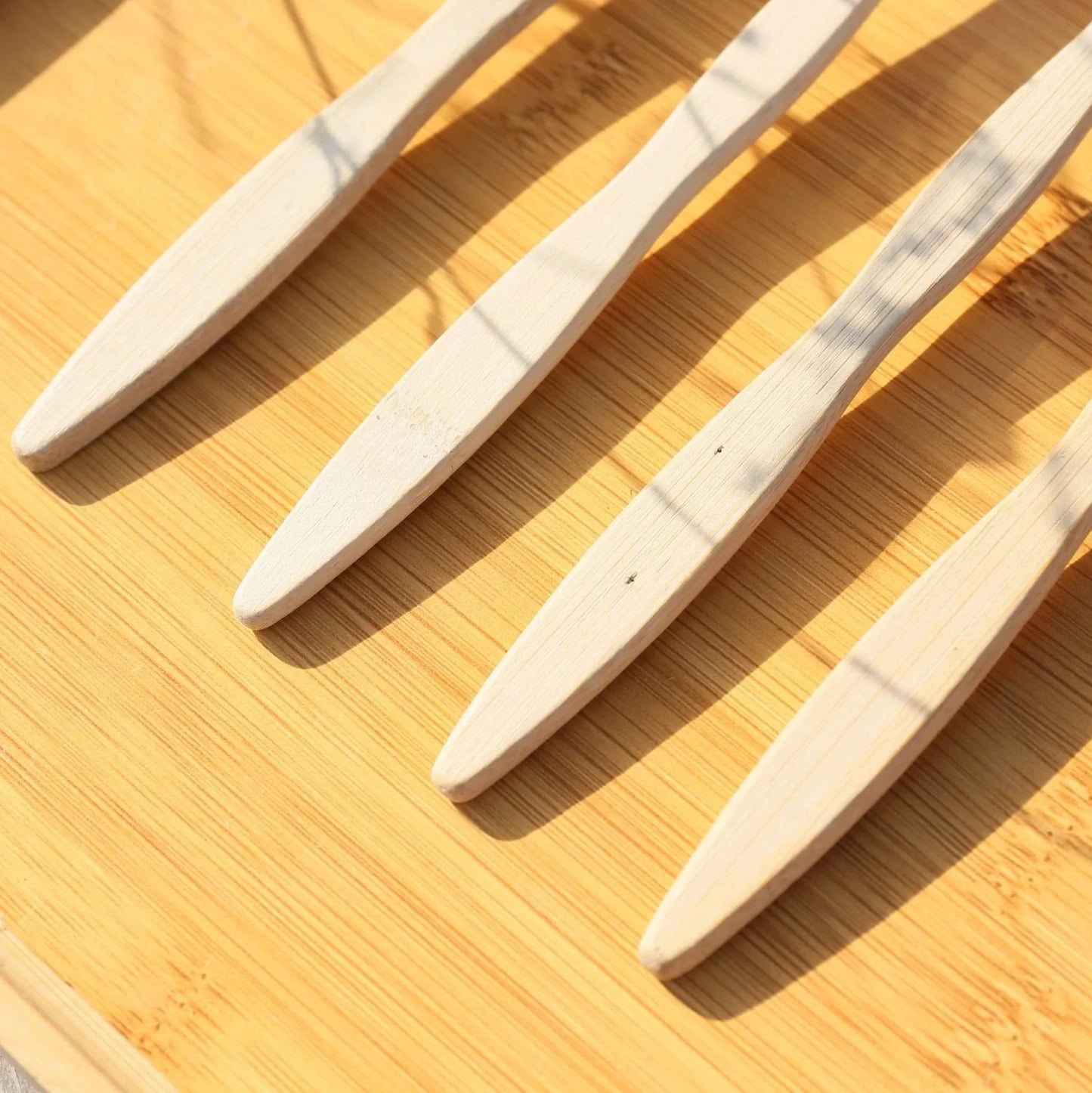 Organic bamboo toothbrush with 17.5cm ergonomic handle and charcoal-infused bristles for sustainable dental care