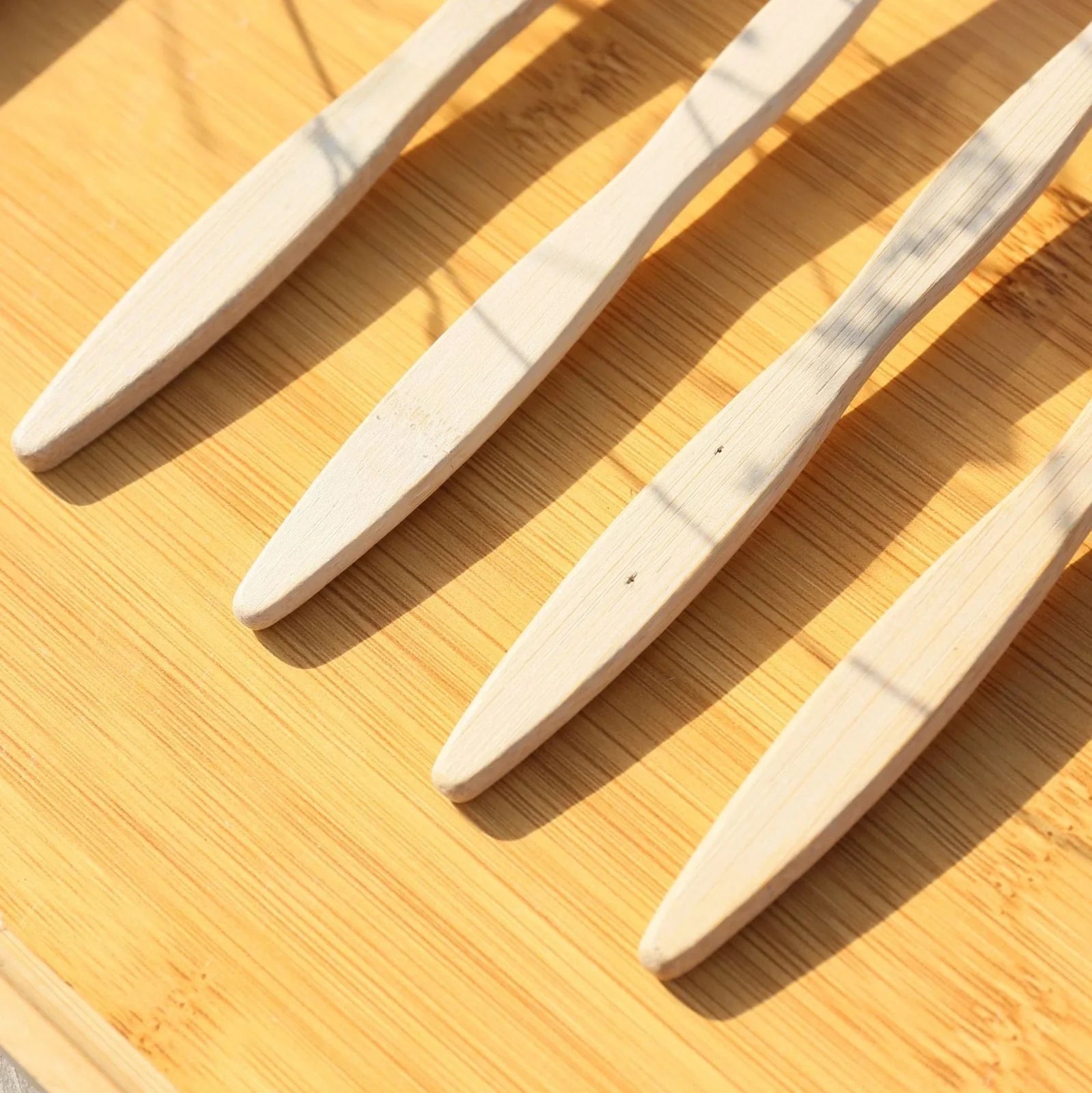 Organic bamboo toothbrush with 17.5cm ergonomic handle and charcoal-infused bristles for sustainable dental care