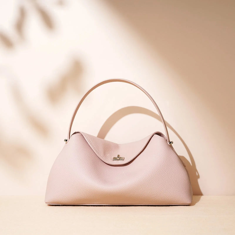 Cowhide leather shoulder messenger bag with pillow-shaped design and double connector straps, available in golden brown, black, cappuccino, milkshake white, and peony pink for everyday professional or casual use