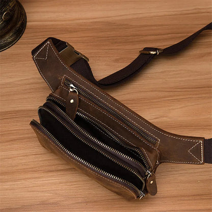 Brown top layer cowhide men's sports waist bag showing 30 cm width, pull closure, and internal phone compartment