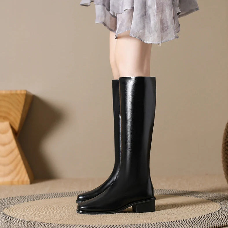 Black square toe over-the-knee boots with 4cm chunky heel showing leather interior and rubber sole