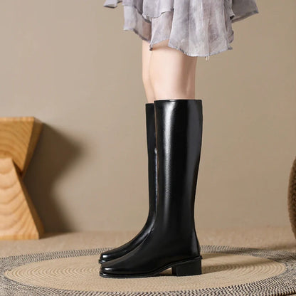 Black square toe over-the-knee boots with 4cm chunky heel showing leather interior and rubber sole