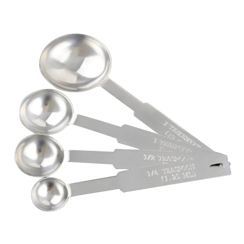 Six stainless steel measuring spoons with engraved markings and D-shape ring, sizes 1/8 tsp to 1 Tbsp