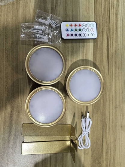 Black magnetic LED painting lamp with remote control on a white wall.