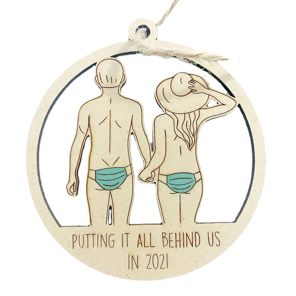 Wooden hollowed-out Christmas ornament with intricate snowman and deer laser-cut design