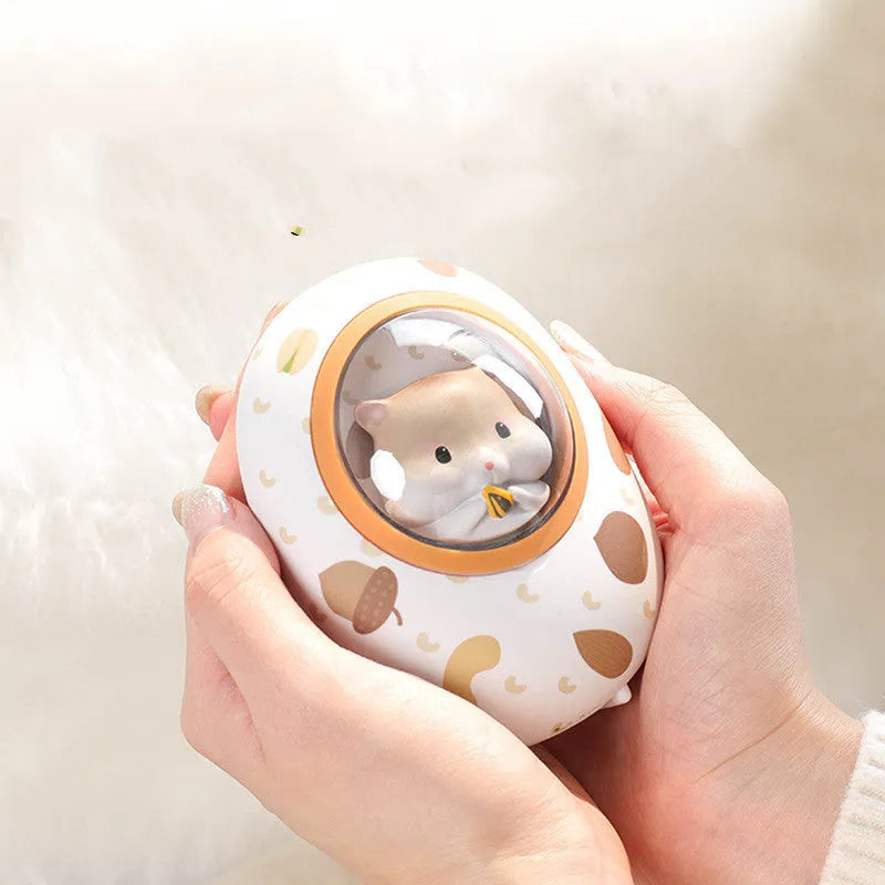 White Hamster space capsule design hand warmer and power bank unit showing its compact size.